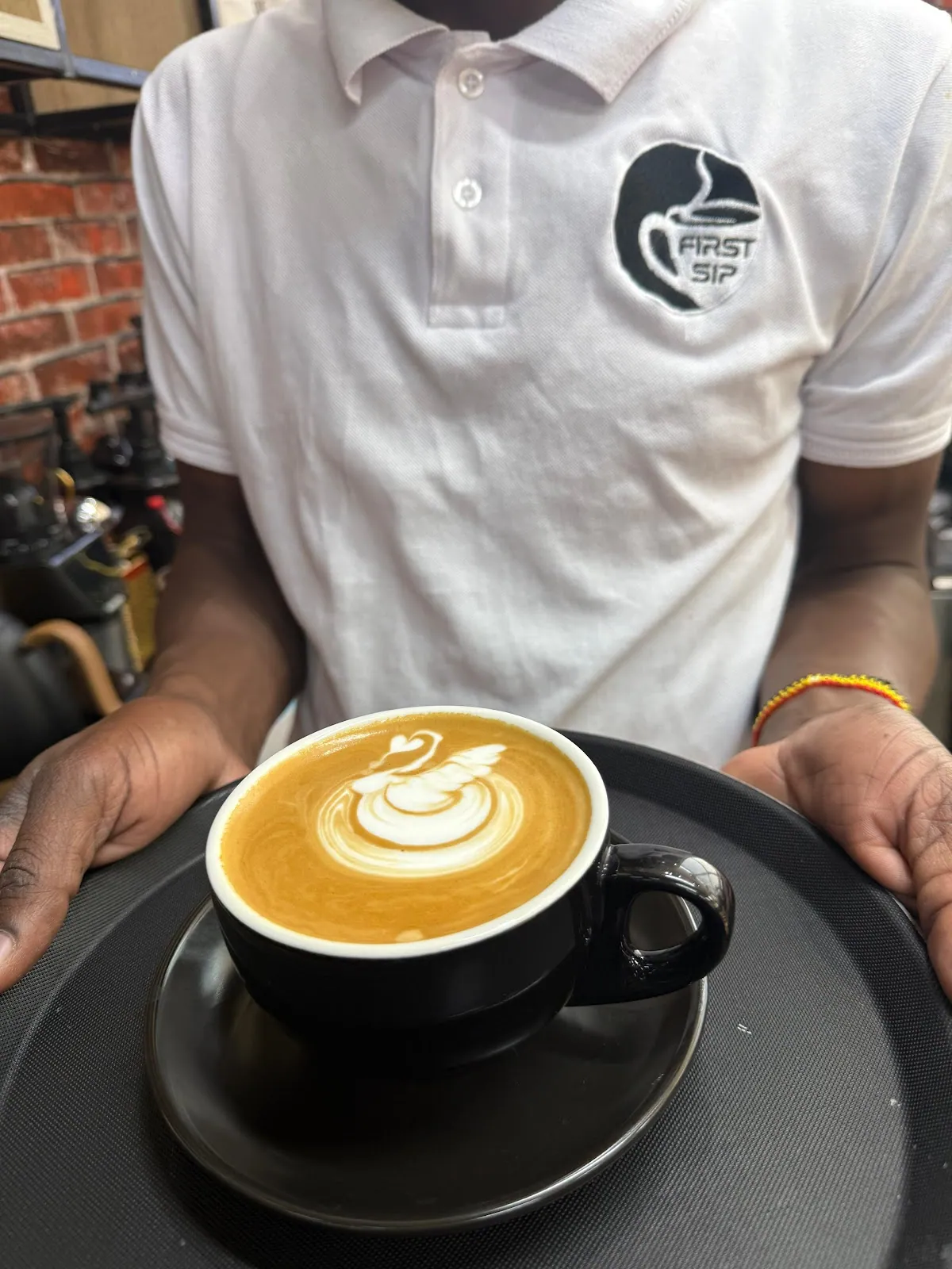 Barista serving a flat white